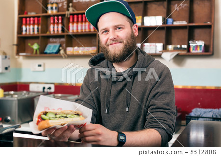 salesman with hotdog in fast food snack bar 8312808
