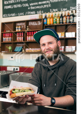salesman with hotdog in fast food snack bar 8312809