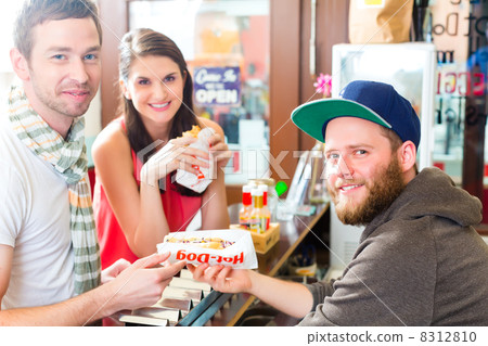 Customers eating Hotdog in fast food snack bar 8312810