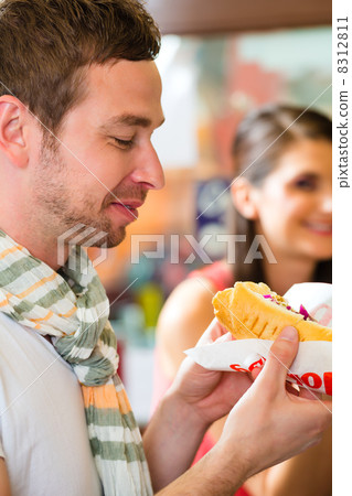 Customers eating Hotdog in fast food snack bar 8312811