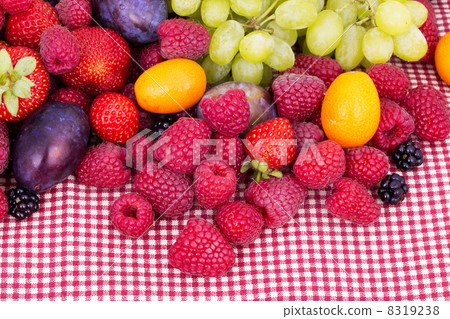 tasty summer fruits on a red tablecloth tasty summer fruits on a red tablecloth 8319238