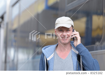 Passenger with phone against a train 8325182