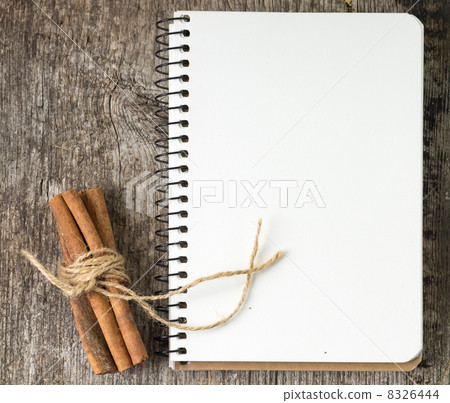 Blank Recipe book with bunch of cinnamon on old wood board Blank Recipe book with bunch of cinnamon on old wood board 8326444