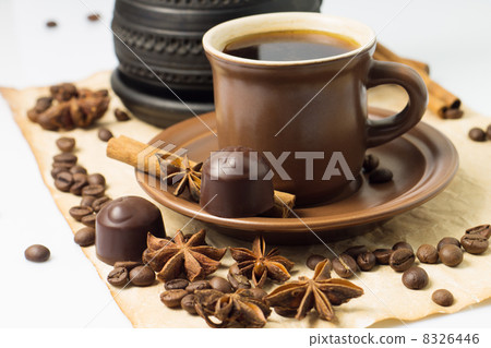 Cup of coffee with coffee beans and chocolate candy Cup of coffee with coffee beans and chocolate candy 8326446