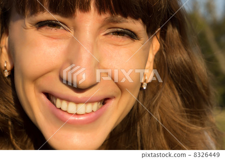 Closeup portrait of beautiful young woman smiling at outdoor 8326449