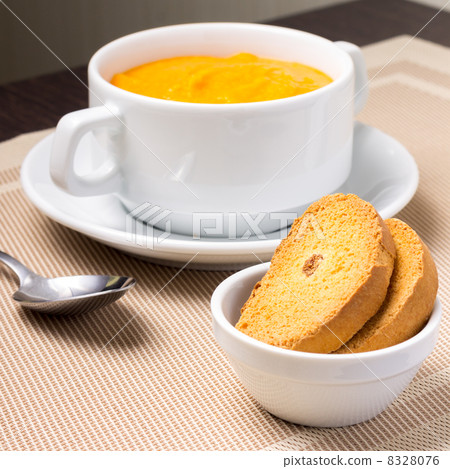 Pumpkin soup in white bowl with crouton 8328076