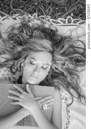 Beautiful girl with book on the grass 8328843