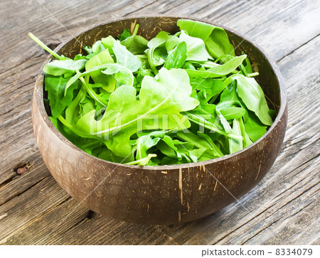 resh arugula salad on wooden table 8334079