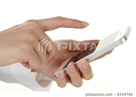 A young woman handling a smartphone A young woman handling a smartphone 8334784