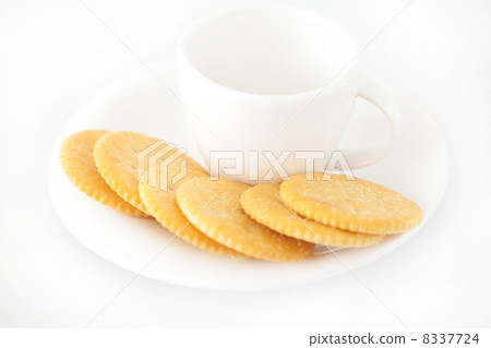 white cup with saucer and crackers white cup with saucer and crackers 8337724