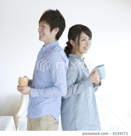 A couple smiling with a cup of coffee 8339371