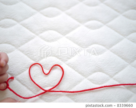 Baby's hand and red thread 8339660