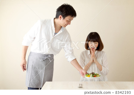 Men carrying food to women 8342193