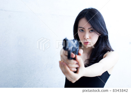 A woman holding a handgun 8343842