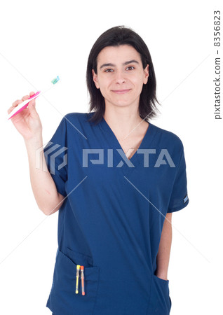 Dentist holding toothbrush Dentist holding toothbrush 8356823