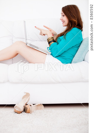 woman sitting and using laptop 8360592
