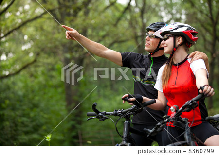 couple riding bicycles outside couple riding bicycles outside 8360799