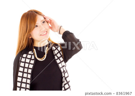 A young girl who scoops her hair freshly while looking up obliquely above A young girl who scoops her hair freshly while looking up obliquely above 8361967