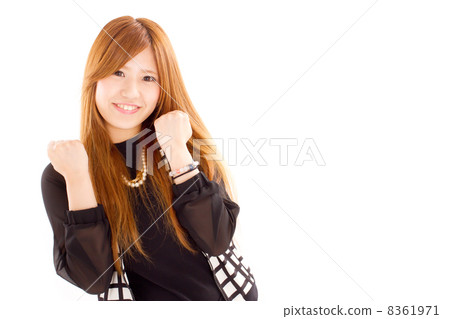 A cute girl holding a fist with both hands and playing a guts pose A cute girl holding a fist with both hands and playing a guts pose 8361971