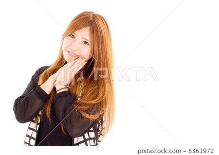 A cute little girl who places both hands next to his cheeks 8361972