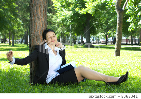 Businesswoman relaxing in park 8368341