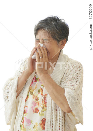 Woman blowing her nose 8370909