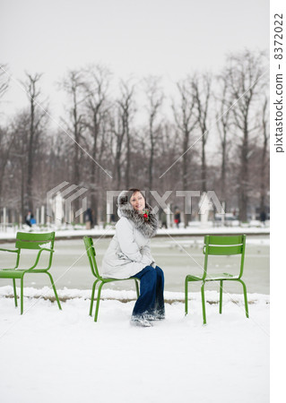 Young woman in Tuileries garden on a winter day Young woman in Tuileries garden on a winter day 8372022