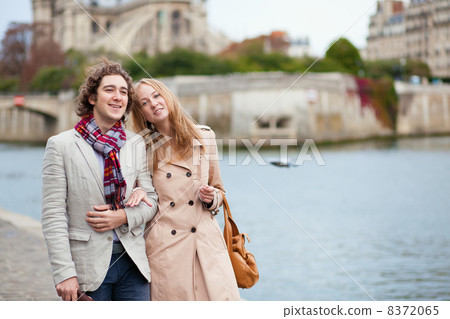 Couple walking by the Seine in Paris 8372065