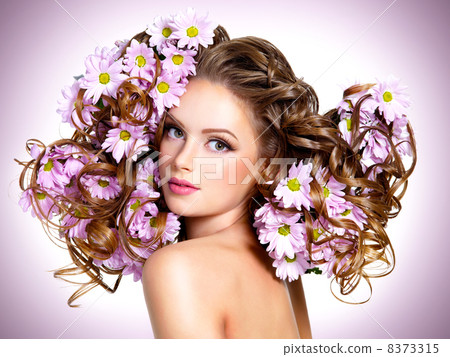 Young beautiful woman with flowers in hairs 8373315