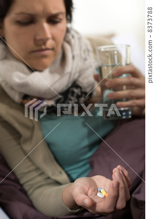 Sick woman taking pills for flu 8373788