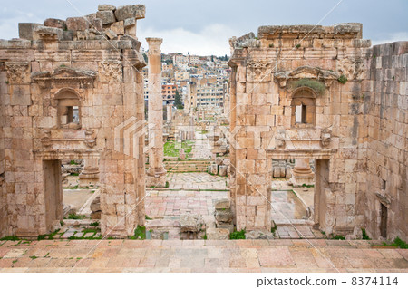 view through antique Artemis temple in ancient city Gerasa to modern Jerash view through antique Artemis temple in ancient city Gerasa to modern Jerash 8374114