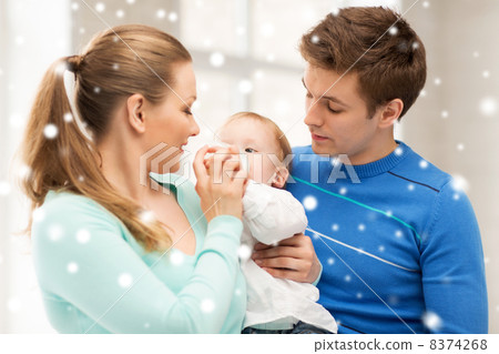 family and adorable baby with feeding-bottle 8374268