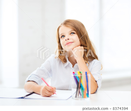 little student girl drawing at school little student girl drawing at school 8374394