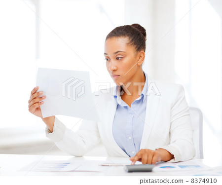 businesswoman working with calculator in office businesswoman working with calculator in office 8374910
