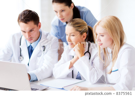 group of doctors looking at tablet pc 8375561