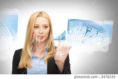 businesswoman pointing at graph clock businesswoman pointing at graph clock 8376249