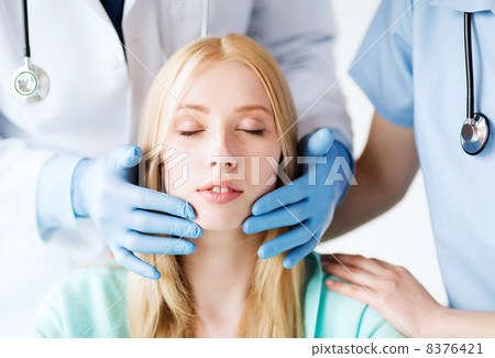 plastic surgeon or doctor with patient 8376421