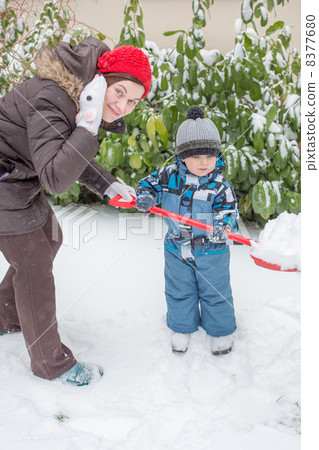 Woman and toddler boy having fun with snow Woman and toddler boy having fun with snow 8377680
