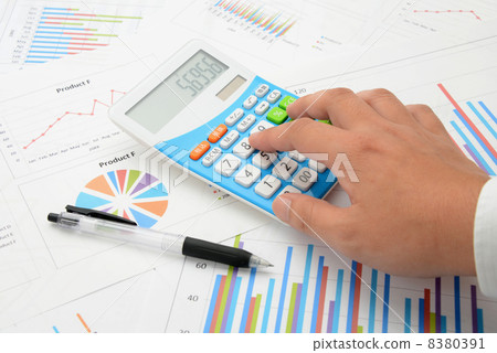 Hand of a businessman using a calculator Hand of a businessman using a calculator 8380391