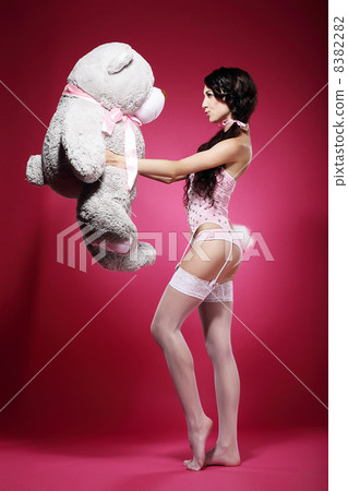 Voluptuous Woman in Tights and Garters with Big Soft Toy 8382282
