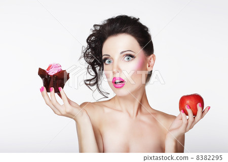 Dieting. Unsure Bewildered Girl Choosing Apple or Cake Dieting. Unsure Bewildered Girl Choosing Apple or Cake 8382295