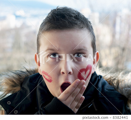 Little boy posing with painted hearts on the face Little boy posing with painted hearts on the face 8382441