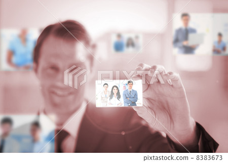 Smiling businessman picking a picture Smiling businessman picking a picture 8383673