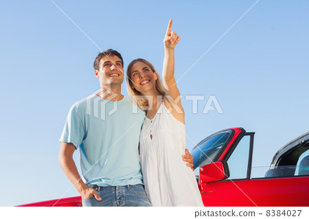 Smiling woman showing something to her handsome boyfriend 8384027