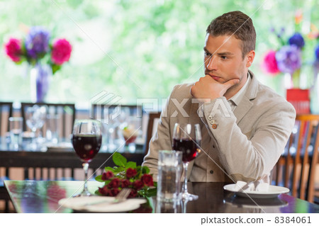 Handsome man waiting for his girlfriend at restaurant 8384061