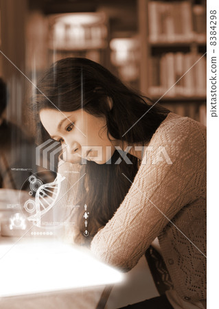 Student using futuristic hologram to learn biology from tablet Student using futuristic hologram to learn biology from tablet 8384298