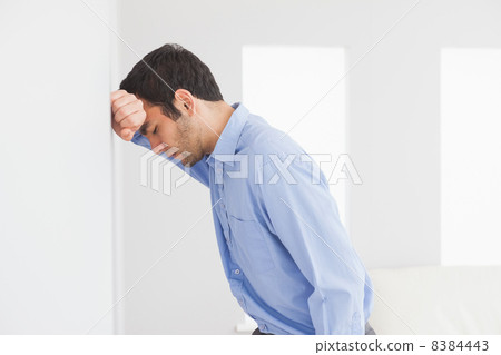 Sad man leaning his head against a wall Sad man leaning his head against a wall 8384443