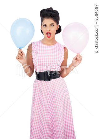 Amused black hair model holding balloons 8384587