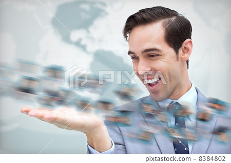 Joyful businessman looking at a picture whirl 8384802