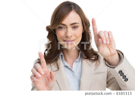 Classy businesswoman touching invisible screen 8385315